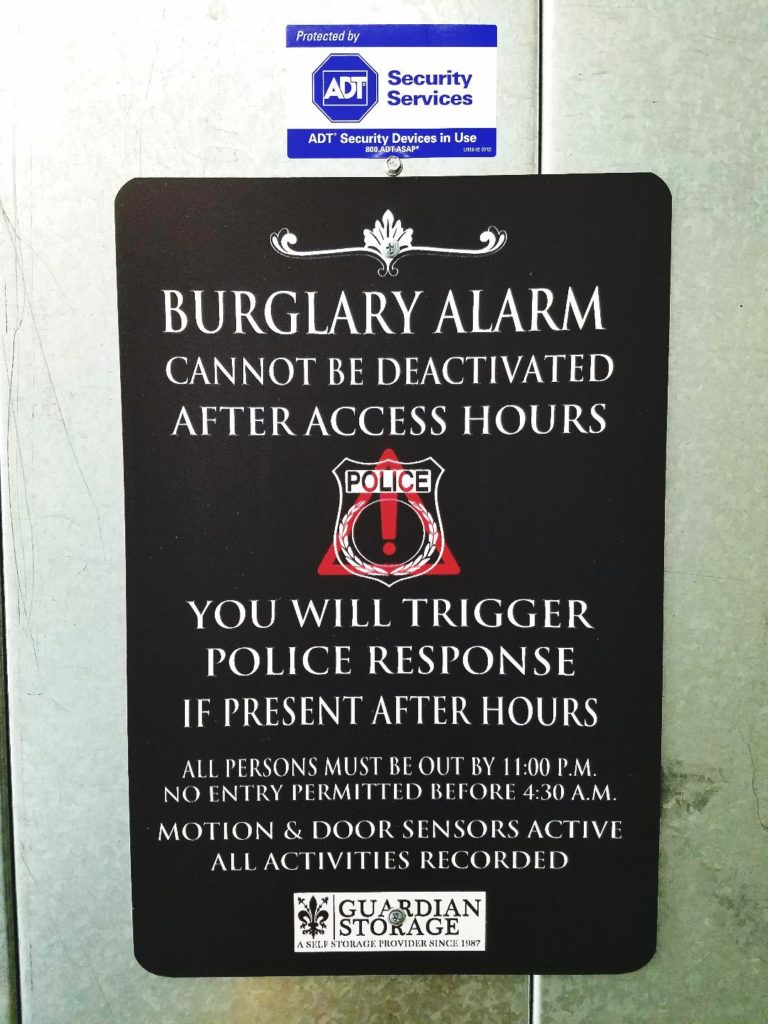Storage facility burglary alarm sign